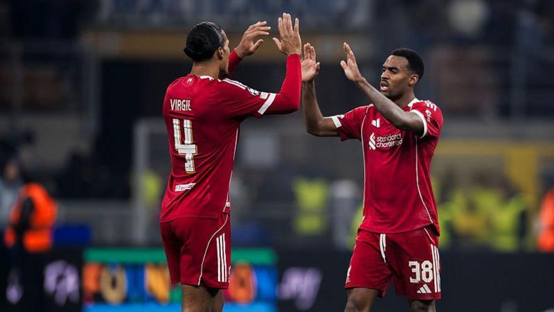 Virgil van Dijk and Ryan Gravenberch high-five each other.