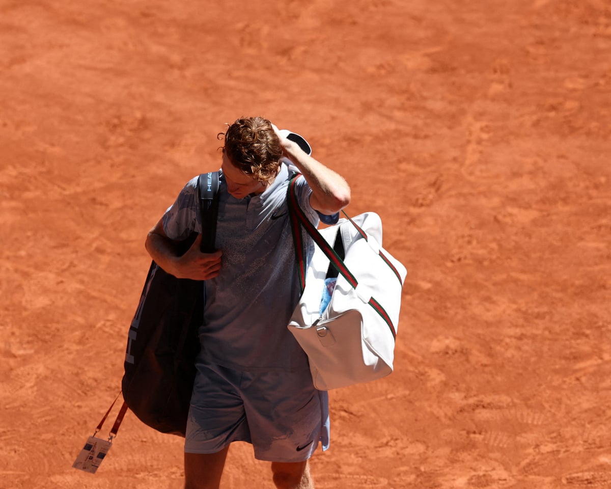 Italy’s Jannik Sinner leaves the court after losing his second round match against Argentina’s Juan Manuel Cerundolo