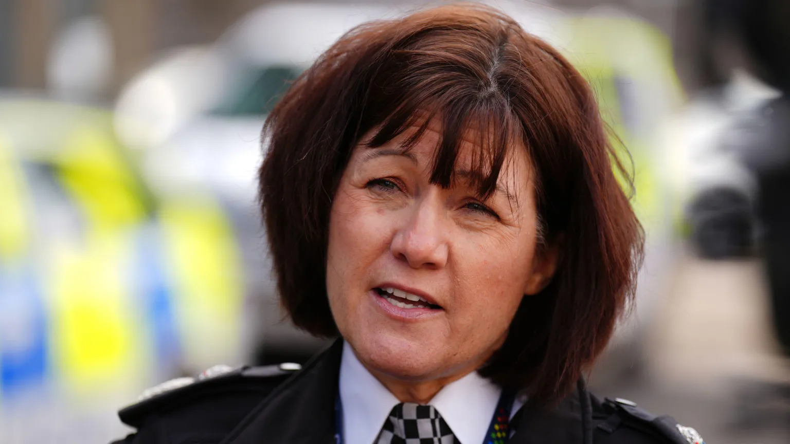 Jo Farrell - a woman with auburn hair, in police uniform.