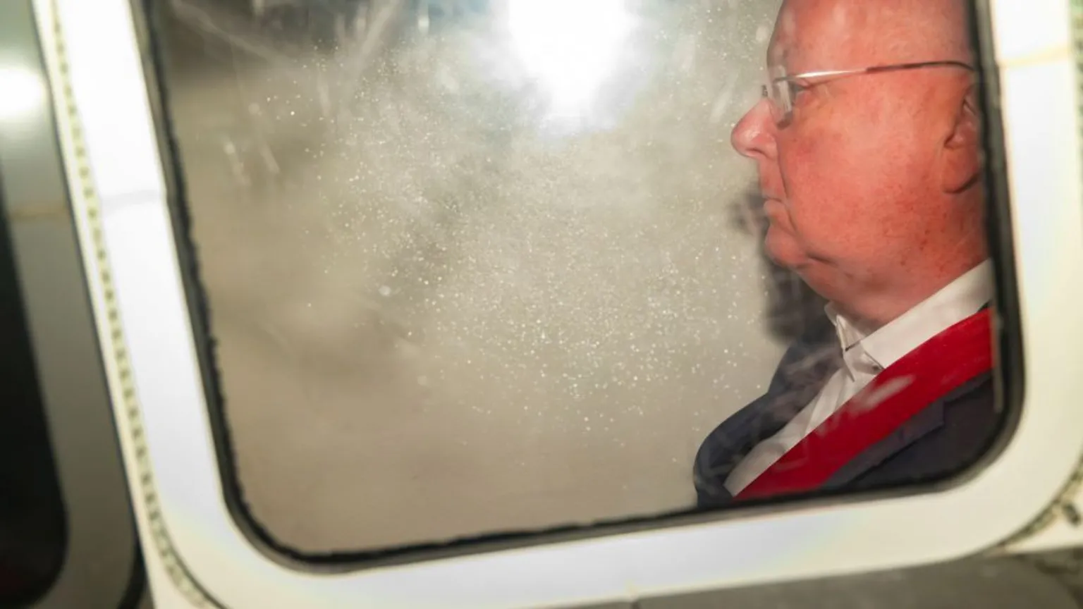 Alan Simpson Peter Murrell, who is bald with glasses, in the back of a white van