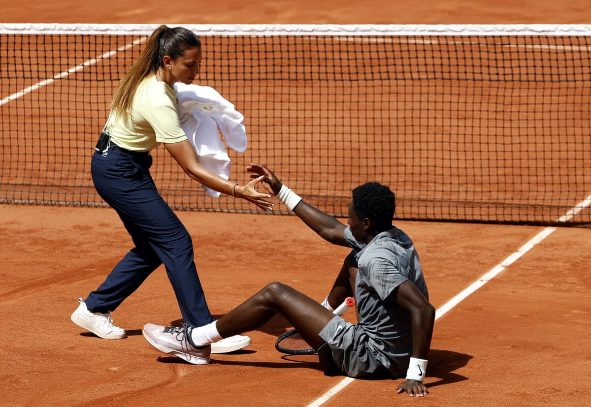 France’s Moise Kouame is helped to get up during his second-round match against Adolfo Daniel Vallejo