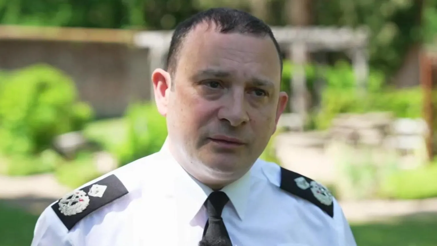 Robert France wearing police uniform and standing in the sunshine
