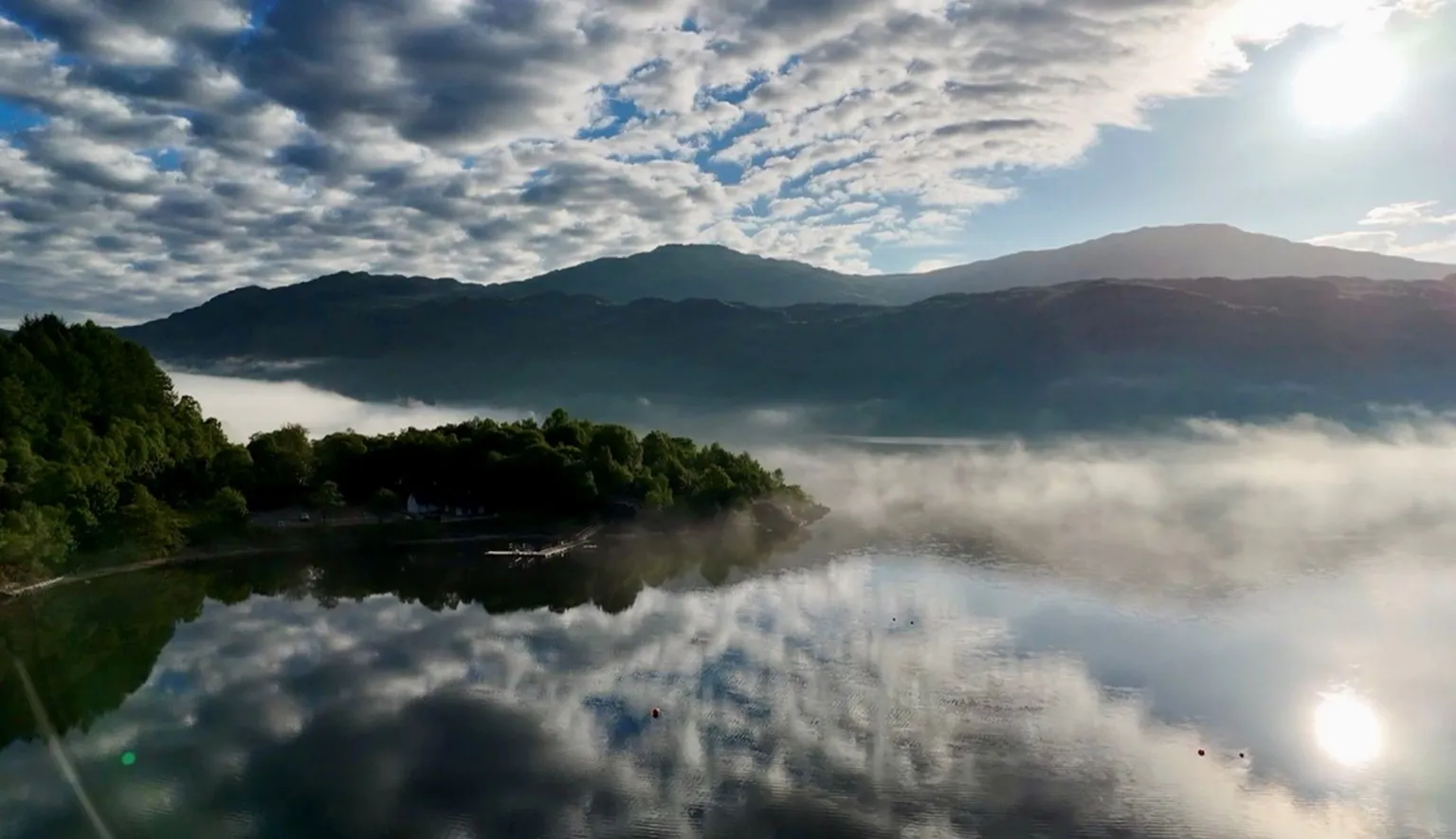 Alan Buchan A misty view of a river with clouds reflected in the water