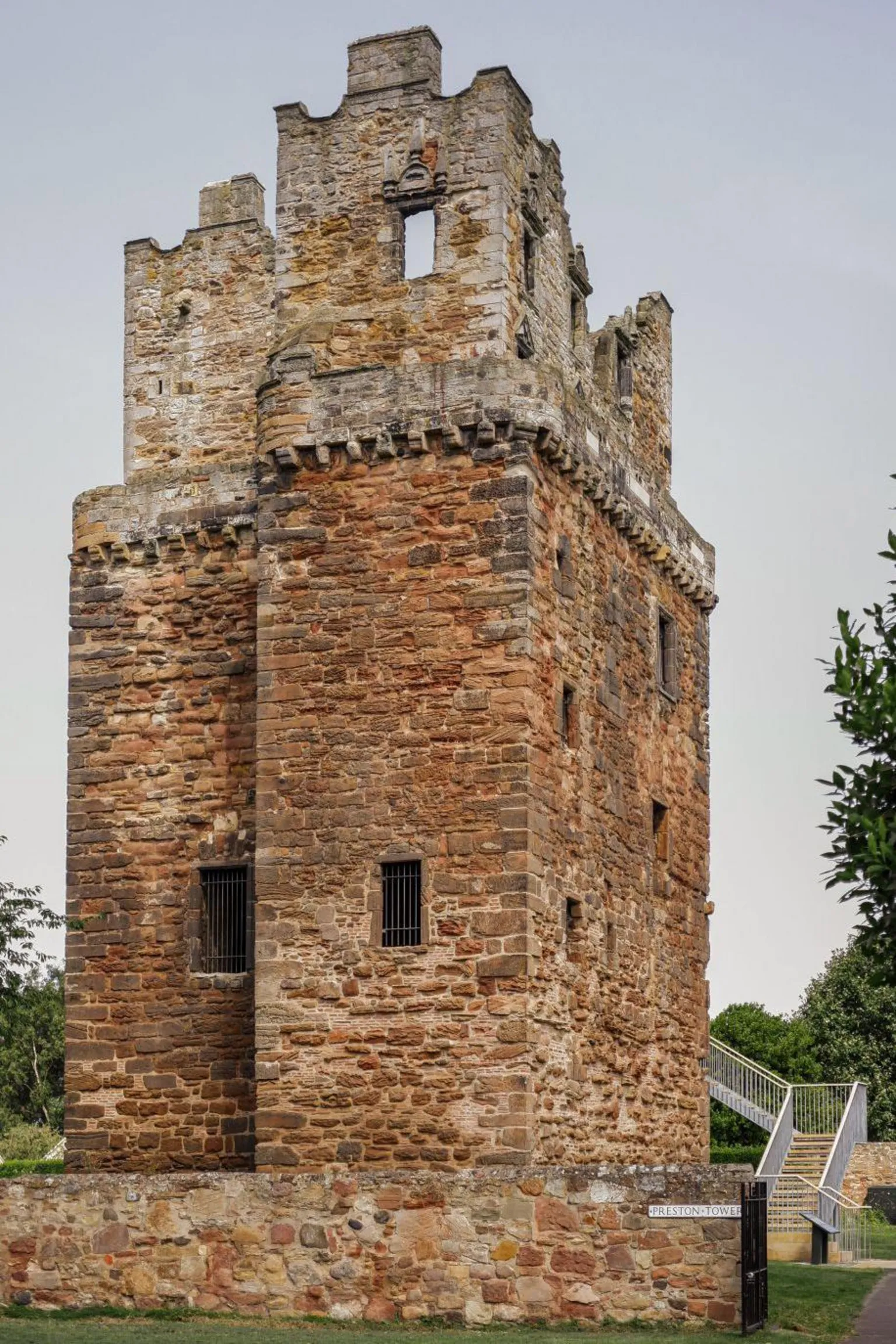 Paula Szturc An historic brick tower, with a modern staircase to the right hand side.