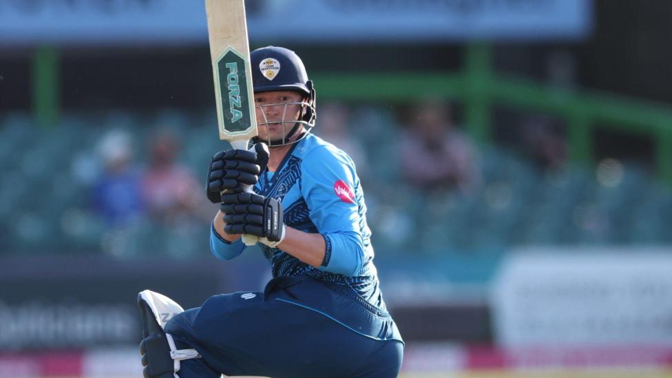 Aneurin Donald, in action for Derbyshire, playing a shot on one knee towards fine leg.