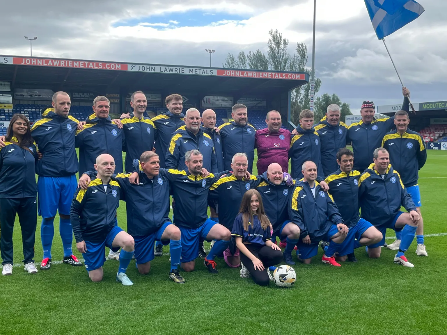 Group of woman and a man with Scotland flag.