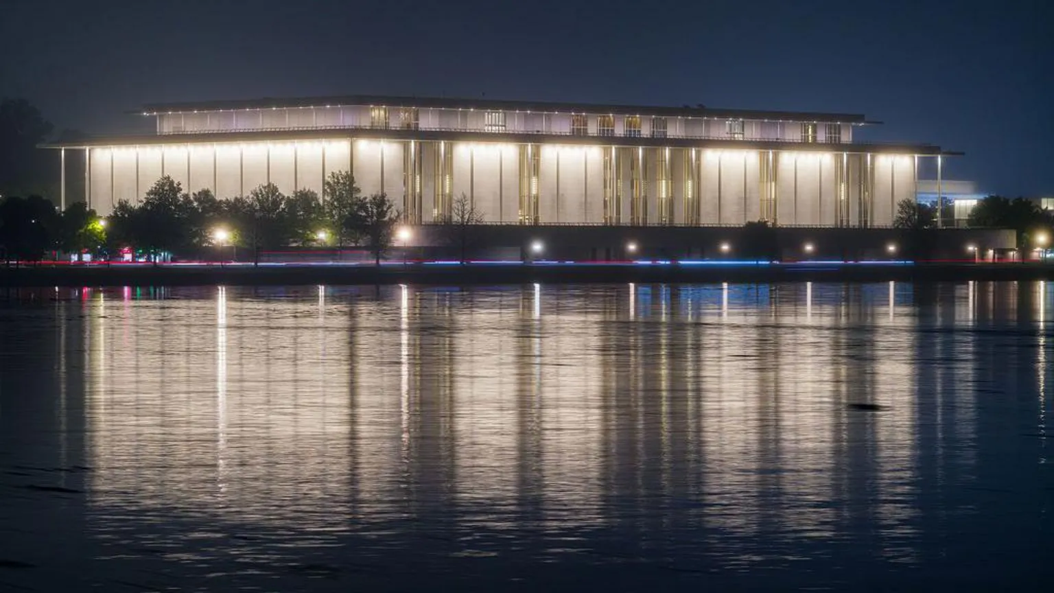  The Kennedy Center is seen lit up in the dark across the Potomac River in Washington DC