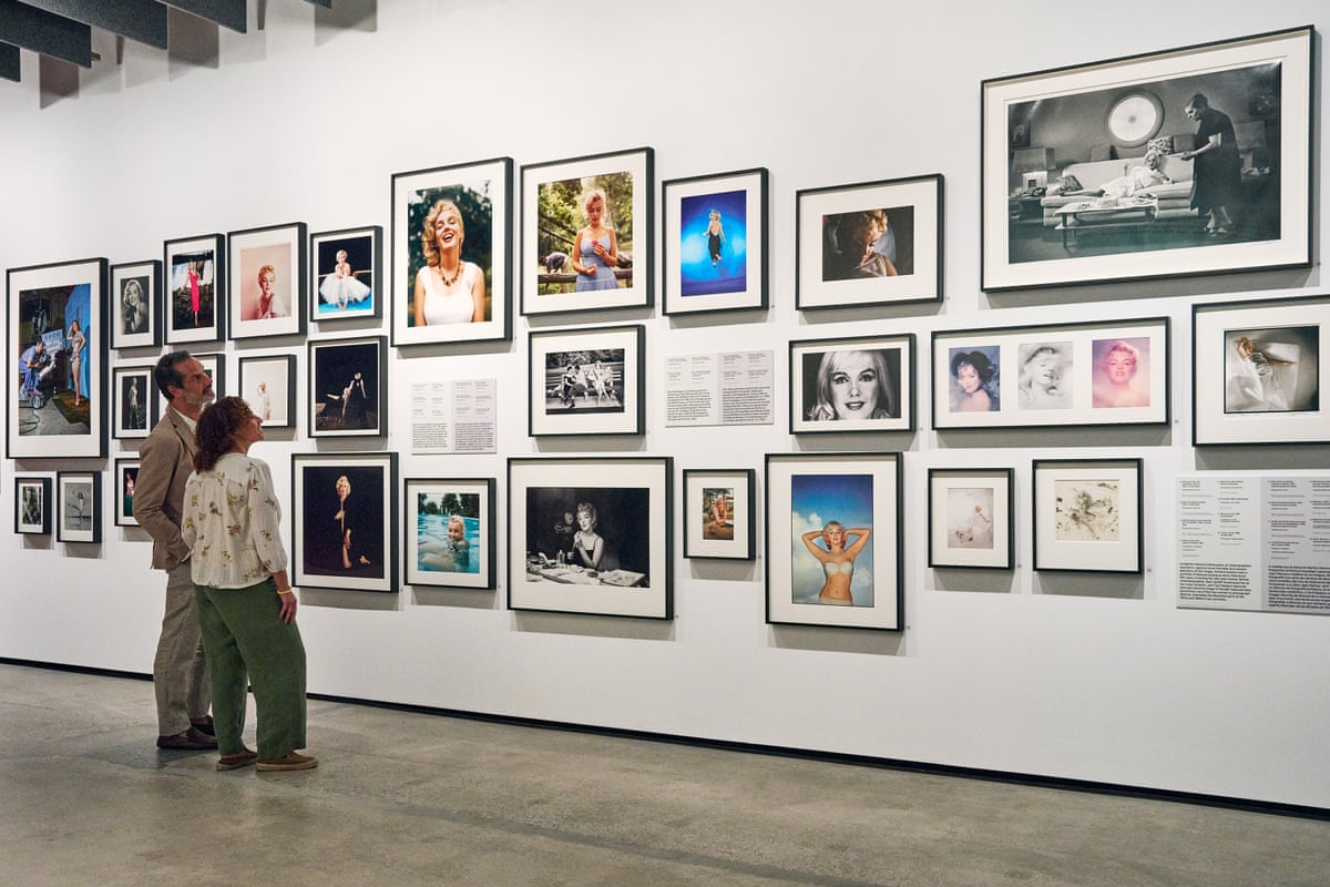 people looking at images on a wall