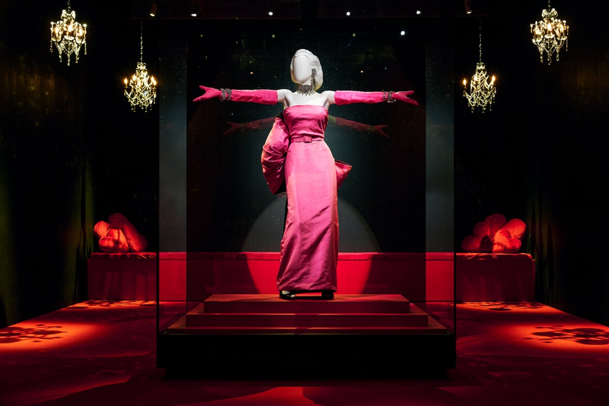 a Marilyn Monroe-like mannequin in a pink dress and pink gloves