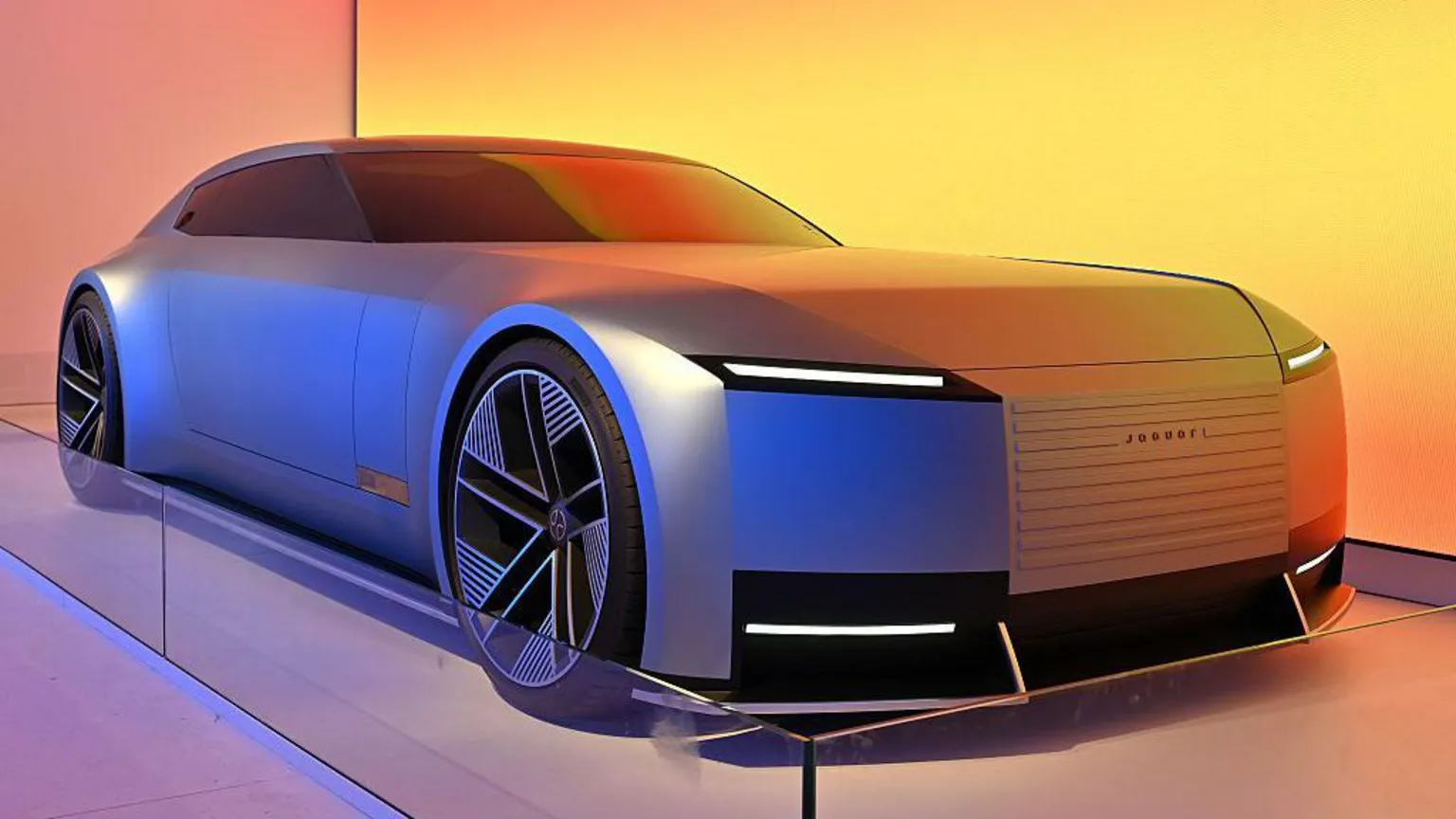  A blue Jaguar Type 00 concept car is displayed at a car show