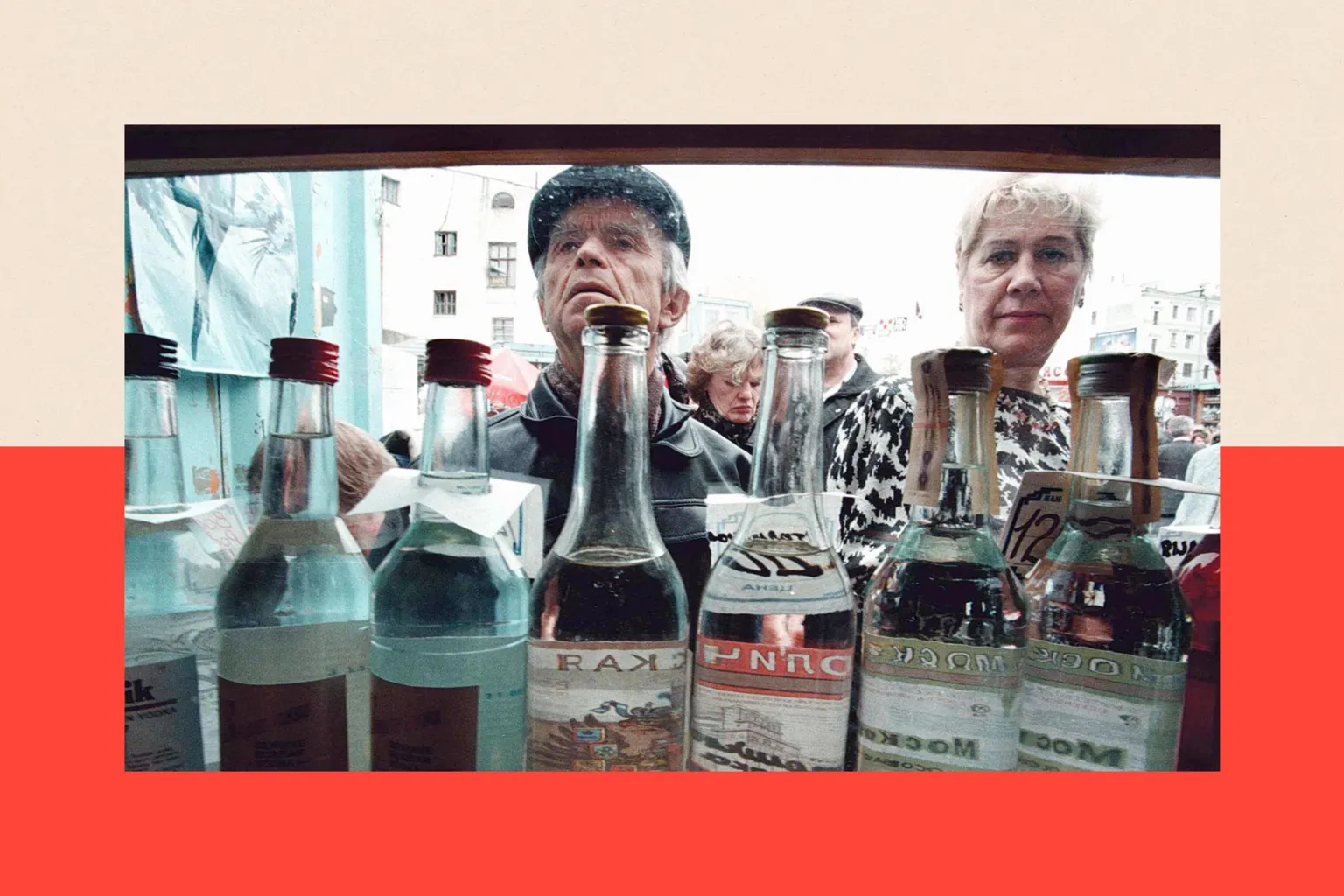 AFP via A man and a woman look into a kiosk selling various brands of vodka in clear bottles.