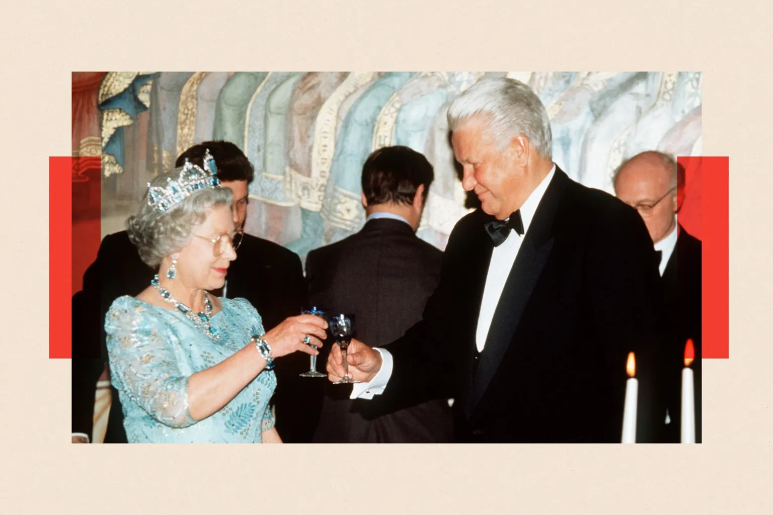 Queen Elizabeth II, wearing a pale blue gown and a tiara, toasts Boris Yeltsin (right) who is wearing a dinner jacket
