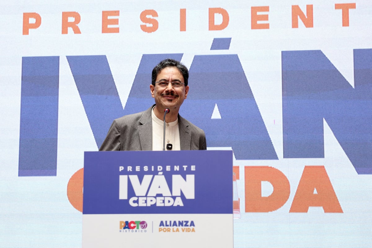 Iván Cepeda stands at a lectern in front of a backdrop with his name on it