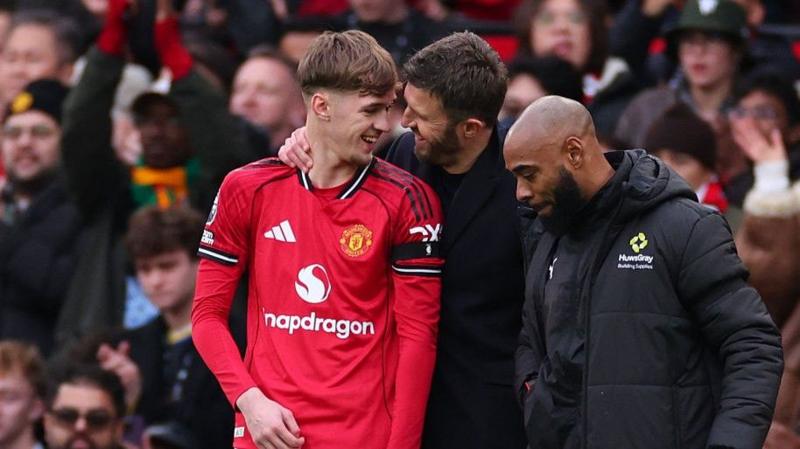 Manchester United head coach Michael Carrick with Tyler Fletcher before he was introduced for his debut against Tottenham at Old Trafford in February