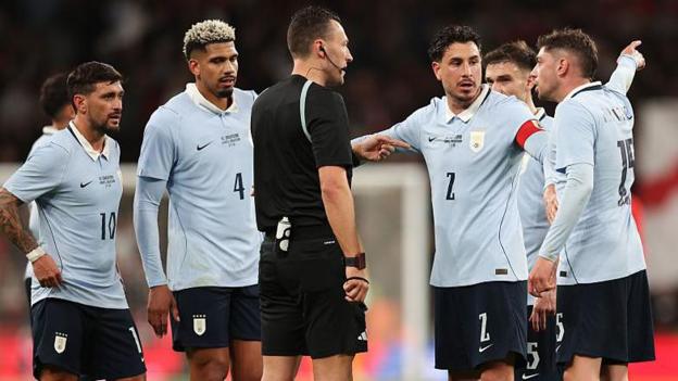 Uruguay's Federico Valverde and Jose Maria Gimenez lead the protests to referee Sven Jablonski after England's opening goal at Wembley Stadium 