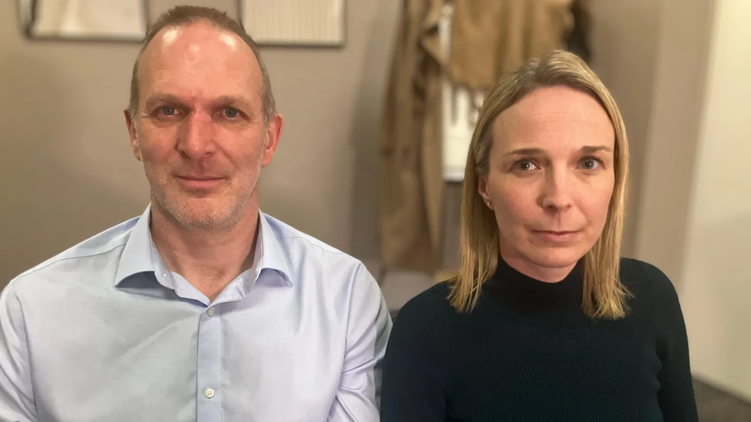 Jack and Sarah Hawkins look at the camera during a BBC interview. Jack is wearing a light blue shirt. Sarah has straight blond hair and is wearing a black top.