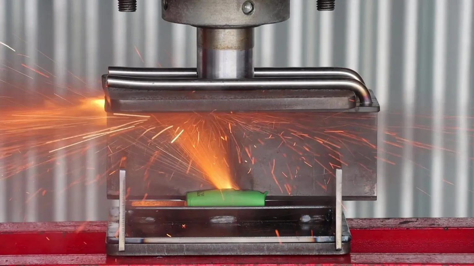 Resonate Testing Limited A green lithium battery exploding as it is being crushed by a hydraulic press