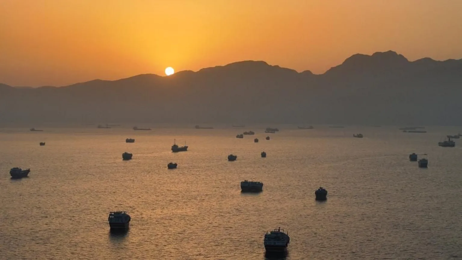 Ships anchored in the Strait of Hormuz at dusk