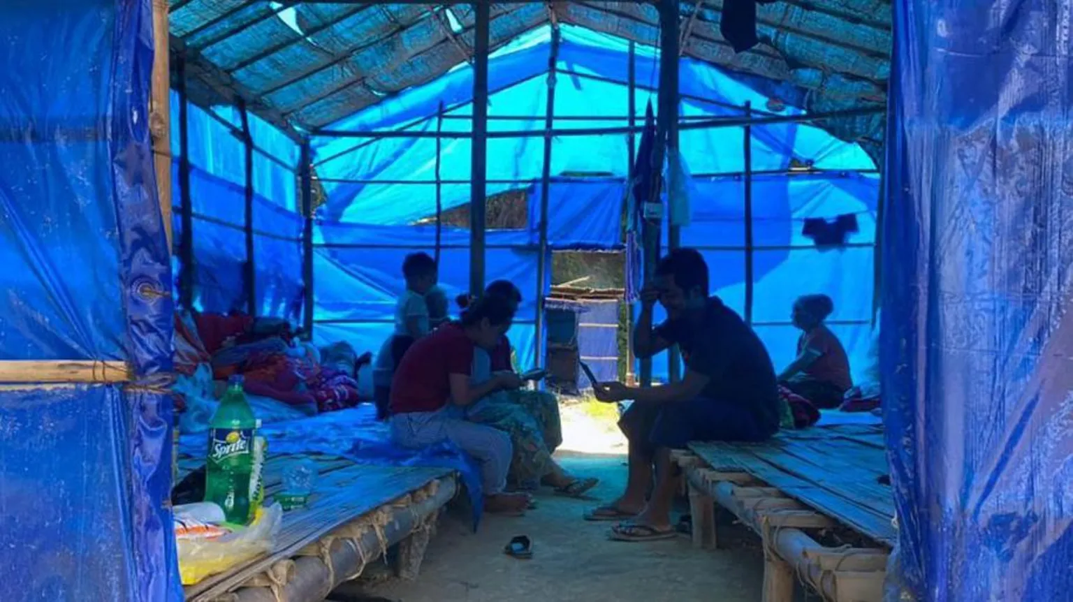 AFP via Refugees who fled Myanmar rest in a basic shelter at Farkawn quarantine camp in India's northeastern state of Mizoram near the Myanmar border on September 23, 2021, after they fled across the border following attacks by Myanmar's military on villages in western Chin state. 