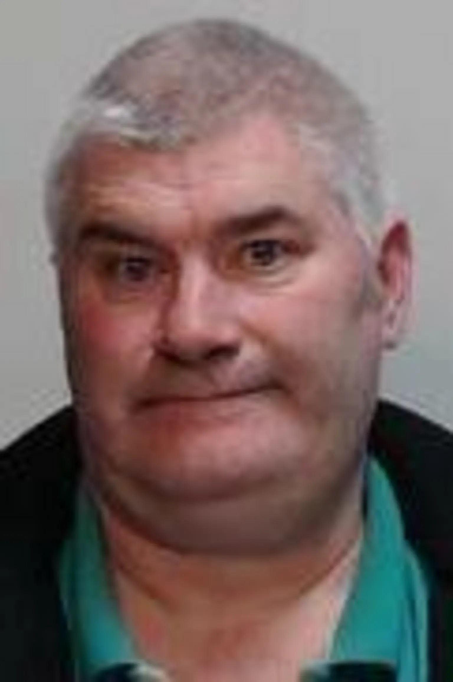 Police Scotland A mugshot of a man with grey hair wearing a green polo shirt and black jacket