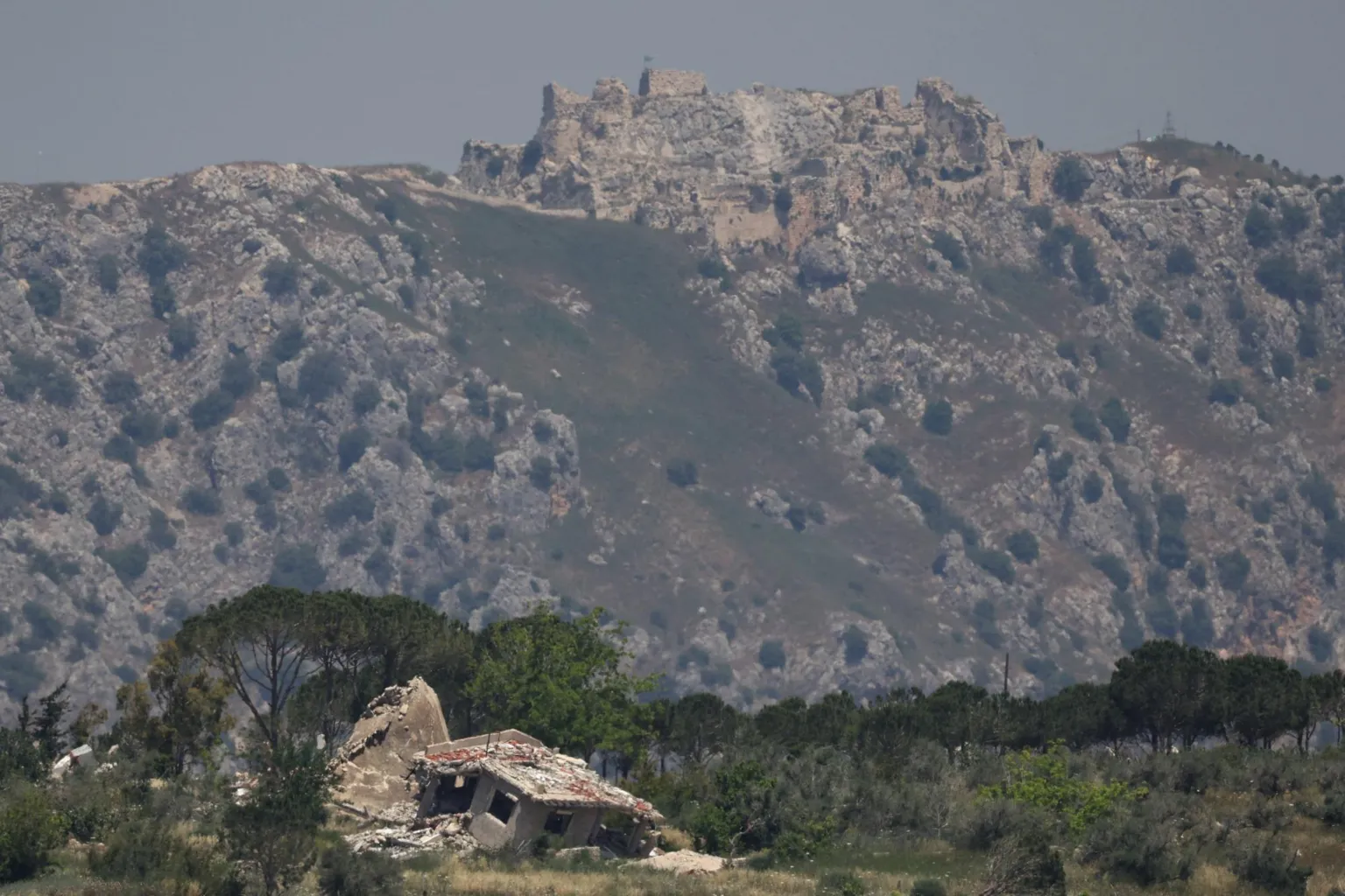  A destroyed house in southern Lebanon, with Beaufort Castle in the background, as seen from northern Israel (2 June 2026)