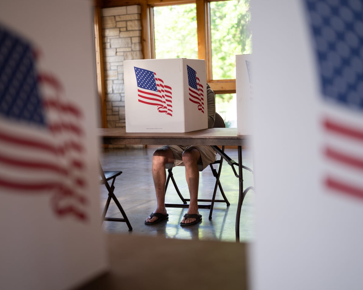 A voter fills out their ballot as Prairie Oak Lodge is used as a polling place in Marion, Iowa.