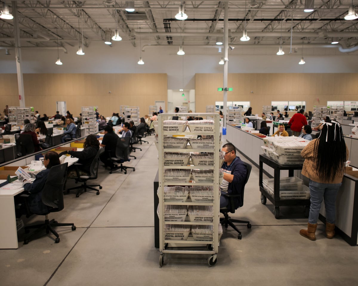 Election workers process ballots during the California primary election in City of Industry, California.