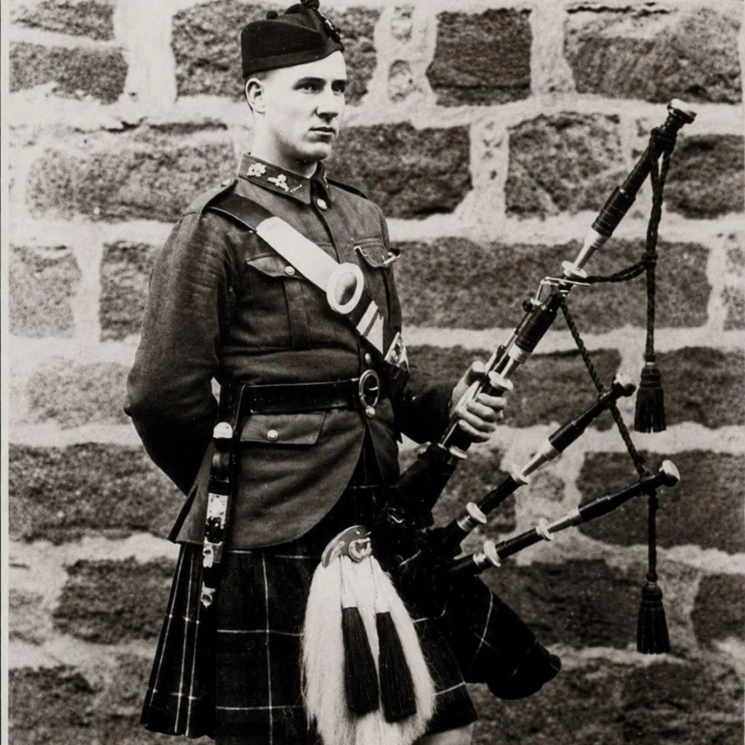 Flett family Black and white photo of piper William Arnot Flett, wearing a kilt, with bagpipes.
