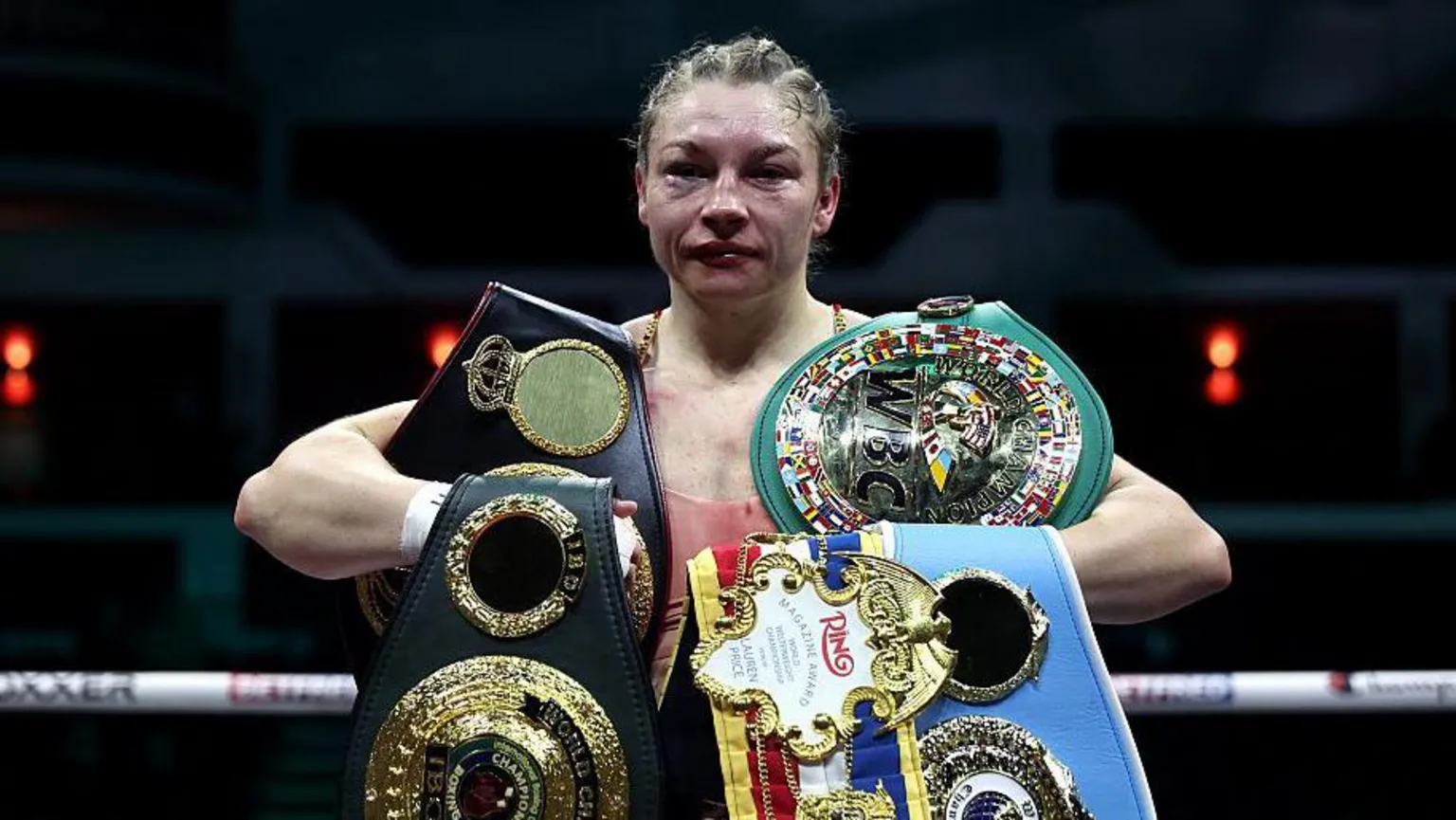 Lauren Price poses for a photo with her belts following victory in the Women's WBA, WBC, IBF, IBO and Ring Magazine World Welterweight Titles' fight