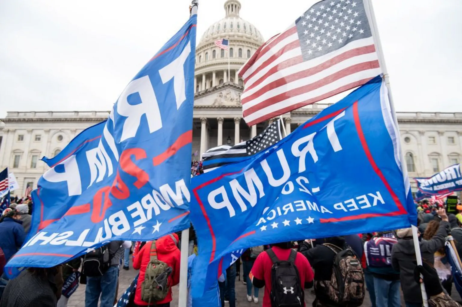 Huge, blue pro-Trump flags are being held in front of the US Capitol on January 6 in 2001 as his supporters headed to Congress and subsequently breached the walls.