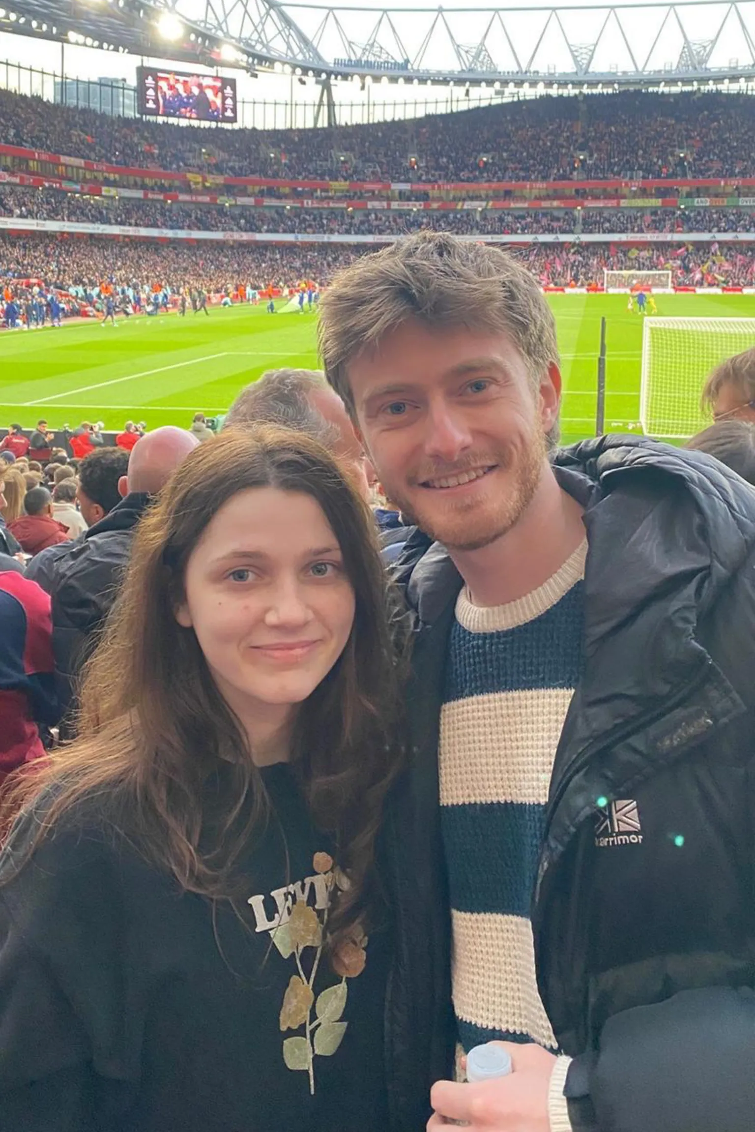 Other Young man and woman at a football ground