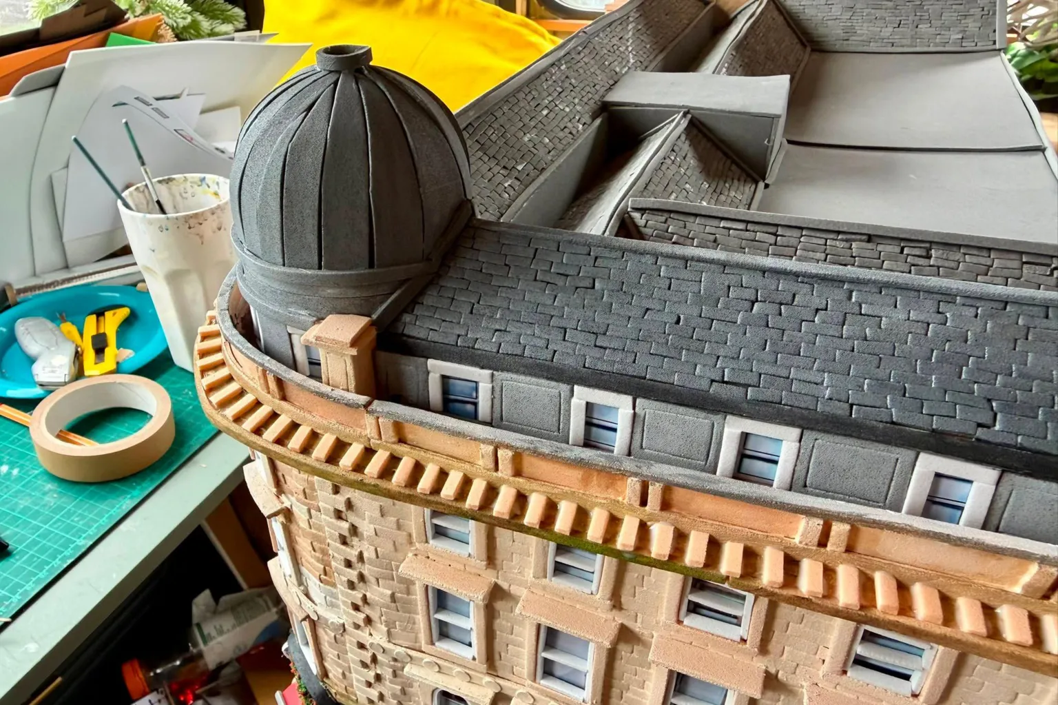 Karen Bones A cardboard model of Union Corner. It is a Victorian Building with a grey slate roof and dome.