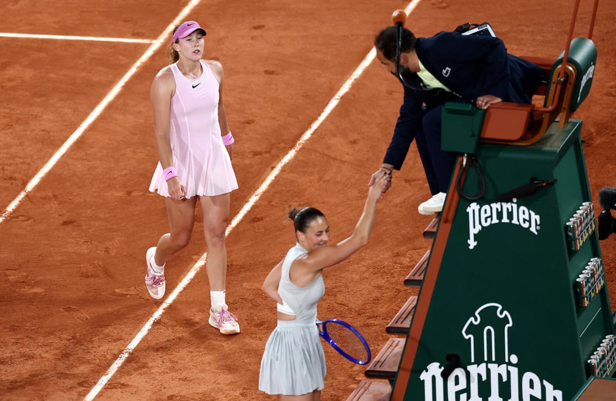 Kostyuk shakes hands with the referee while her opponent hangs back.