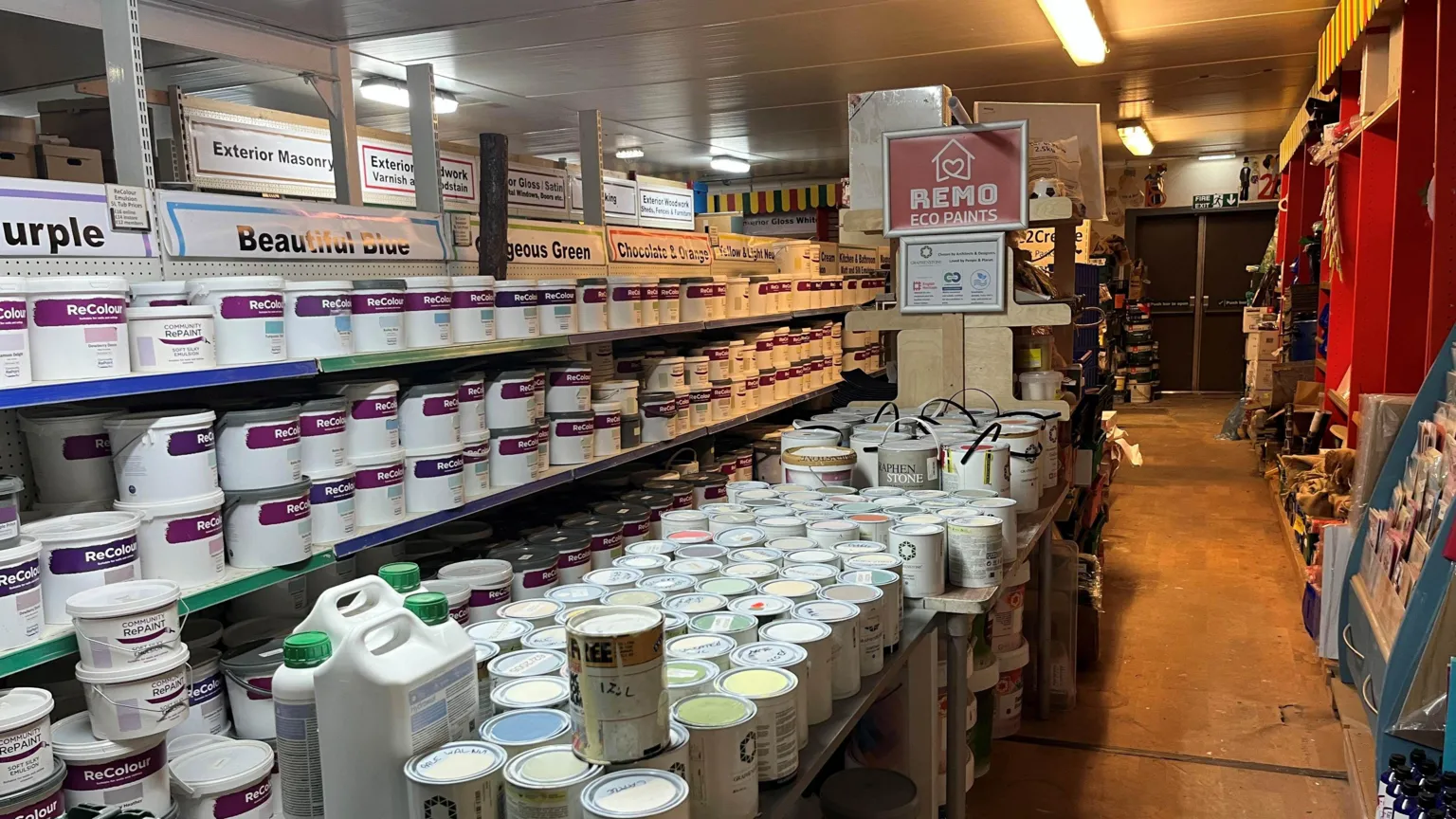 John Devine/BBC A warehouse full of tins of paint – some in used containers and some in clean tubs.