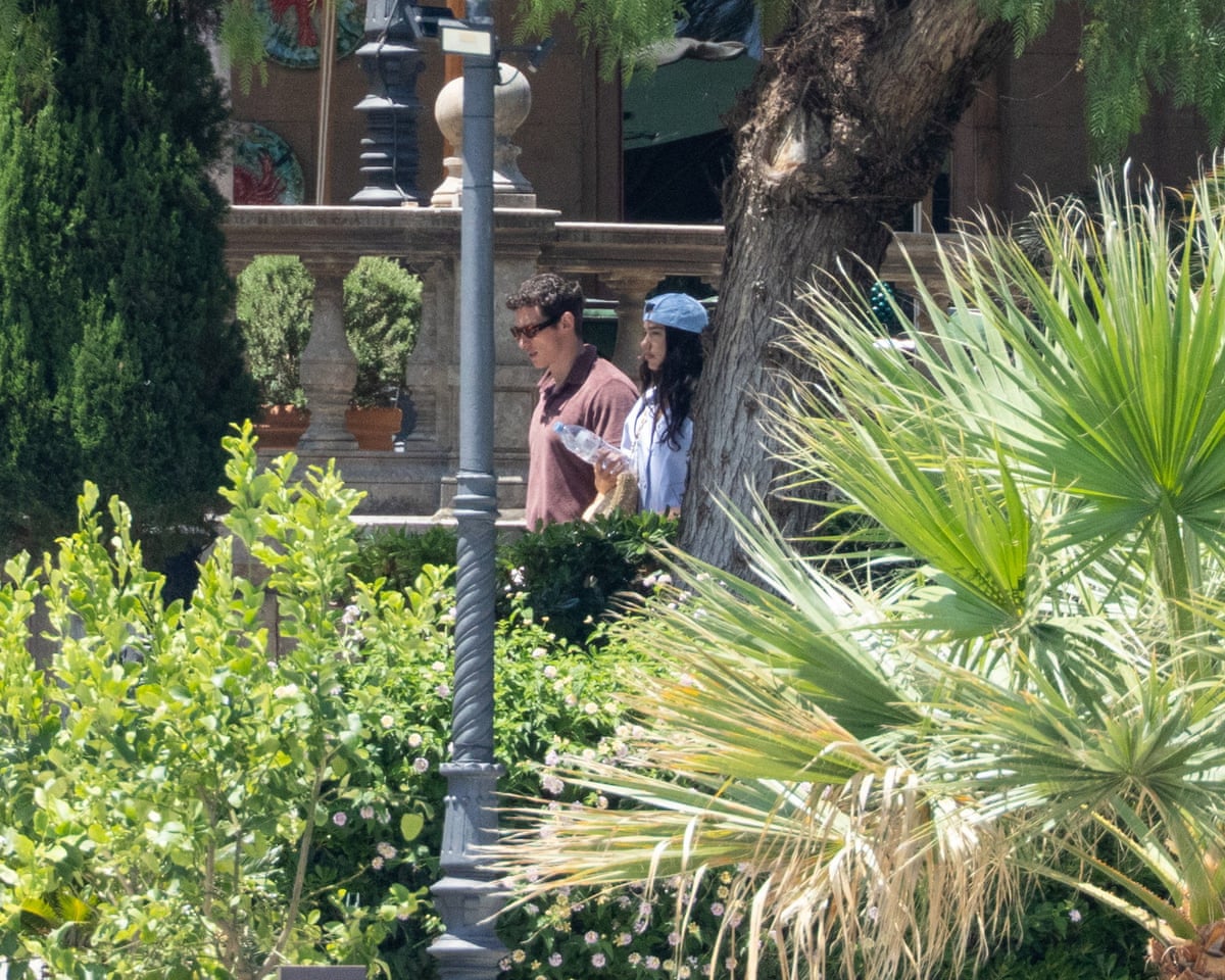 Dua Lipa and Callum Turner walk near the restaurant at Grand Hotel Villa Igiea