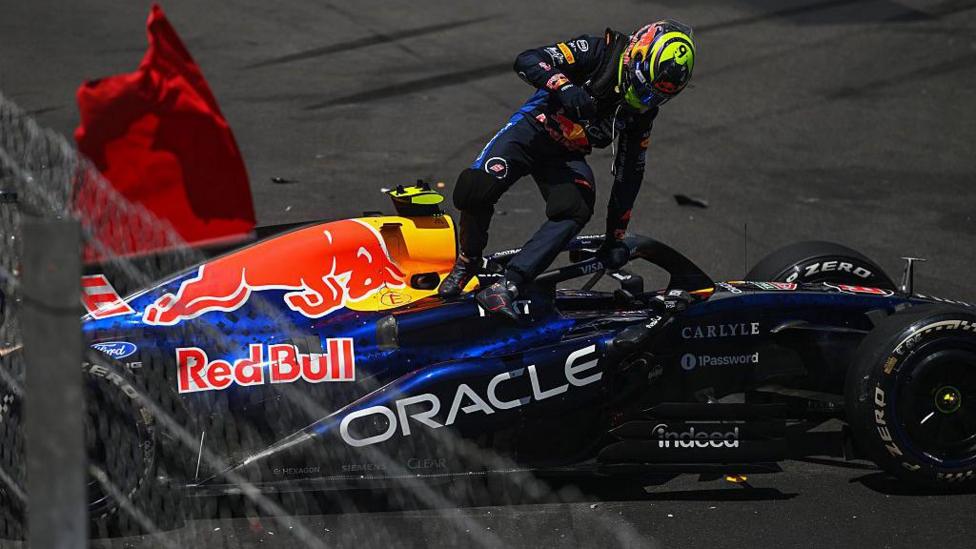 Isack Hadjar climbs out of his Red Bull after crashing in Monaco Grand Prix first practice