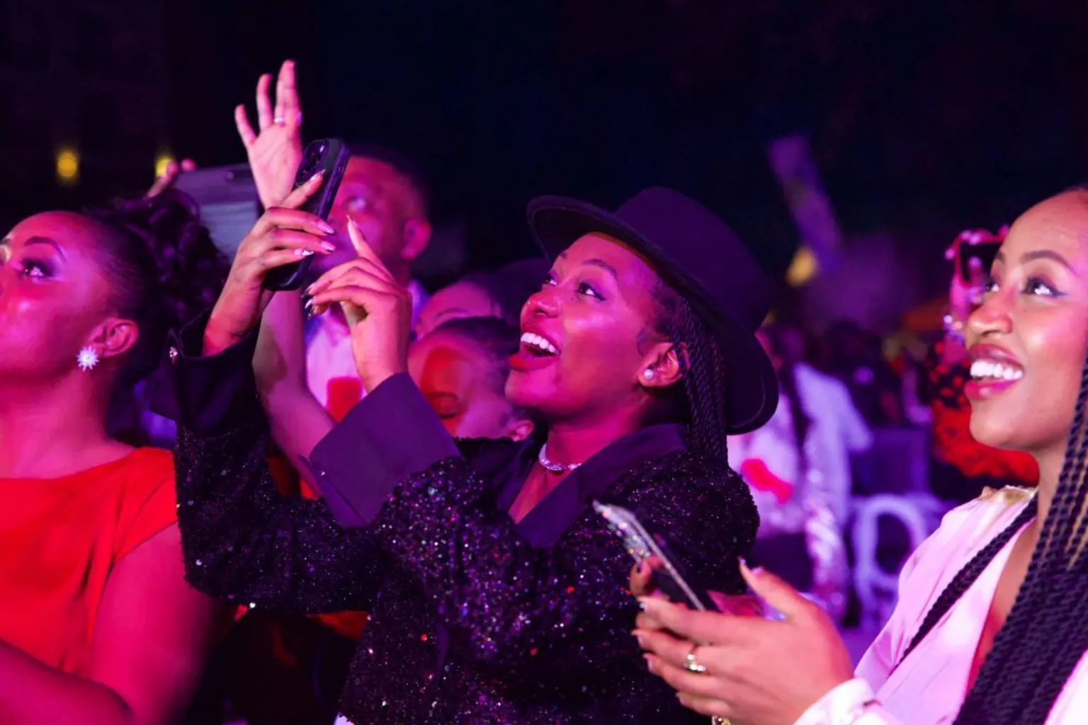 AFP via Fans react during a concert by Fally Ipupa at the Serena Hotel in Goma, DR Congo. Some smile and wave while others film him on their phone.