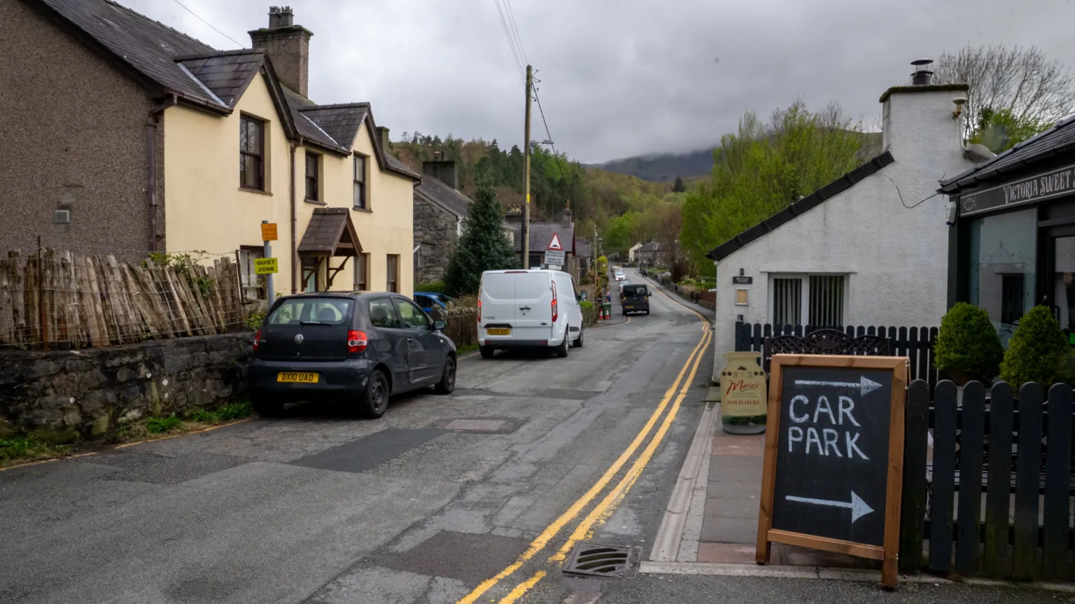 A residential street with a sign for a car park 