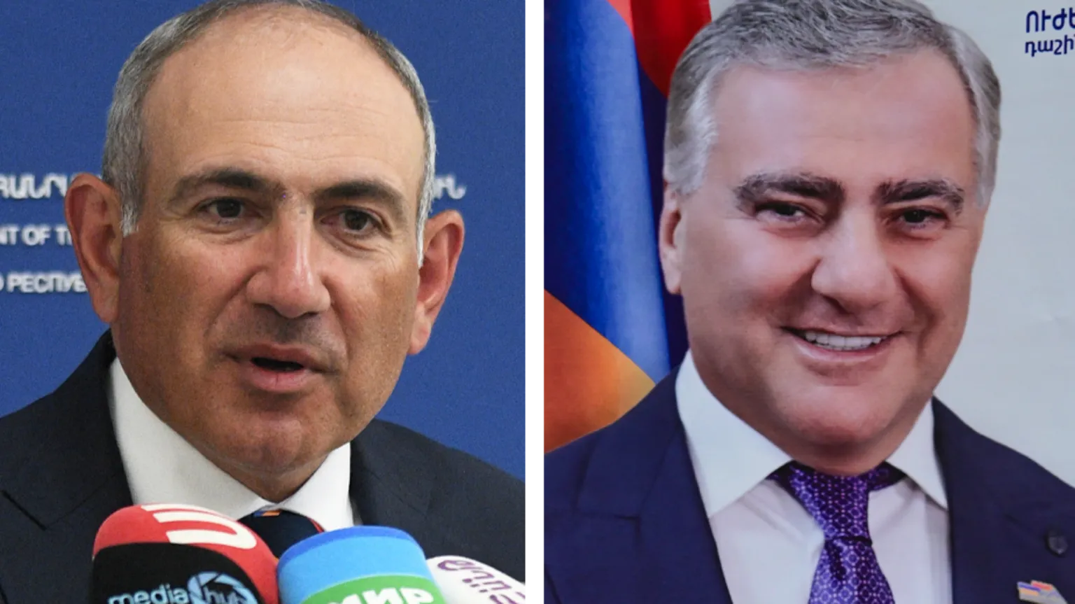  A composite image showing Nikol Pashinyan, an older, balding man in a suit, speaking into microphones, on the left; and a poster of a smiling Samvel Karapetyan, an older man with greying hair in a dark suit and purple tie.