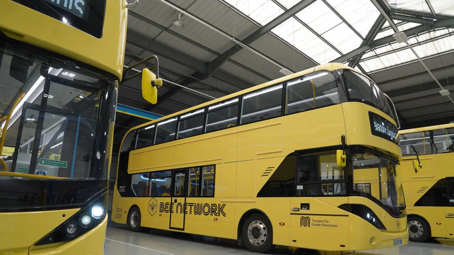  A row of yellow Manchester buses, with Bee Network written on the side of each one.