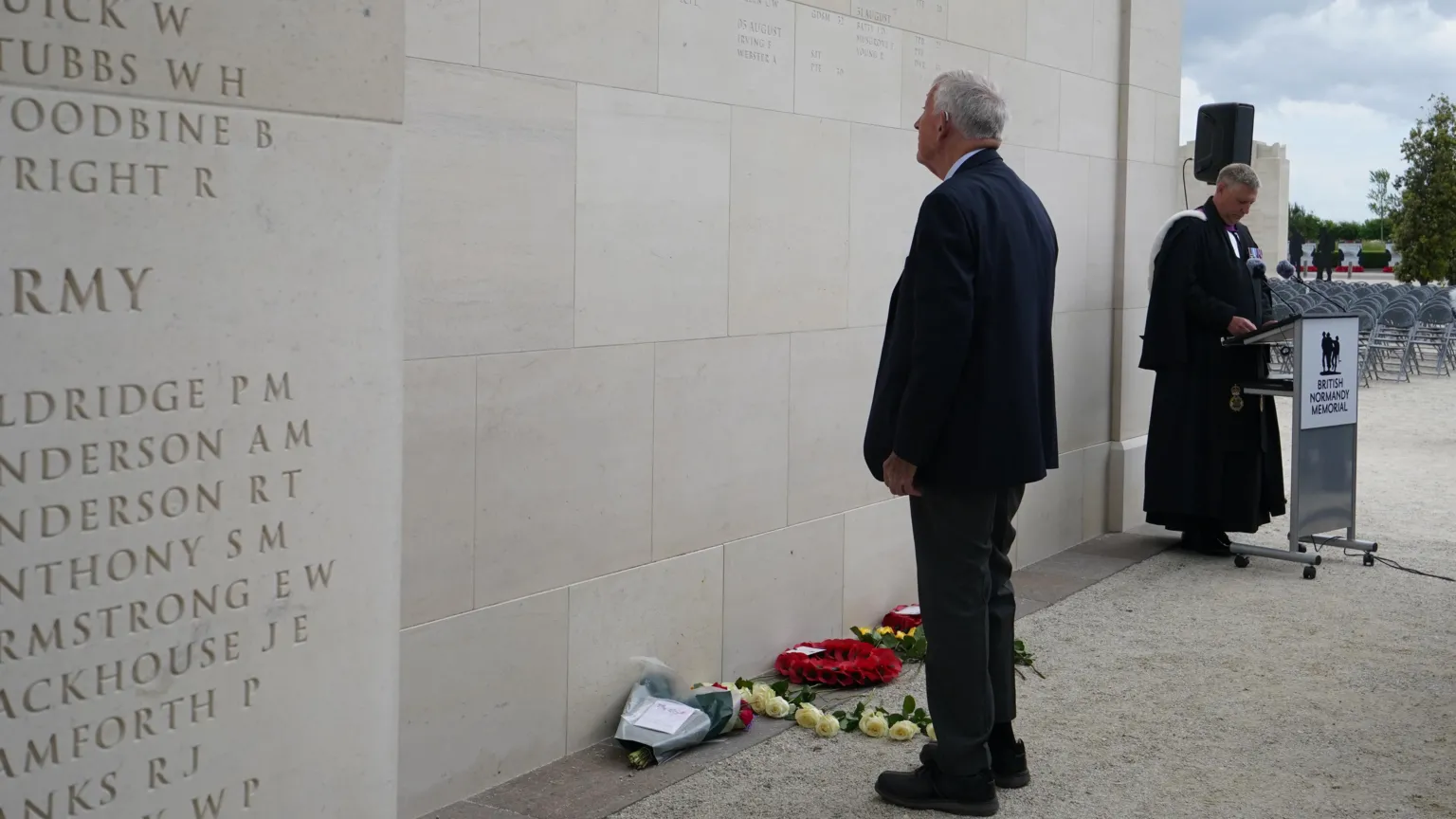  John Green stands in front of the British Normandy Memorial