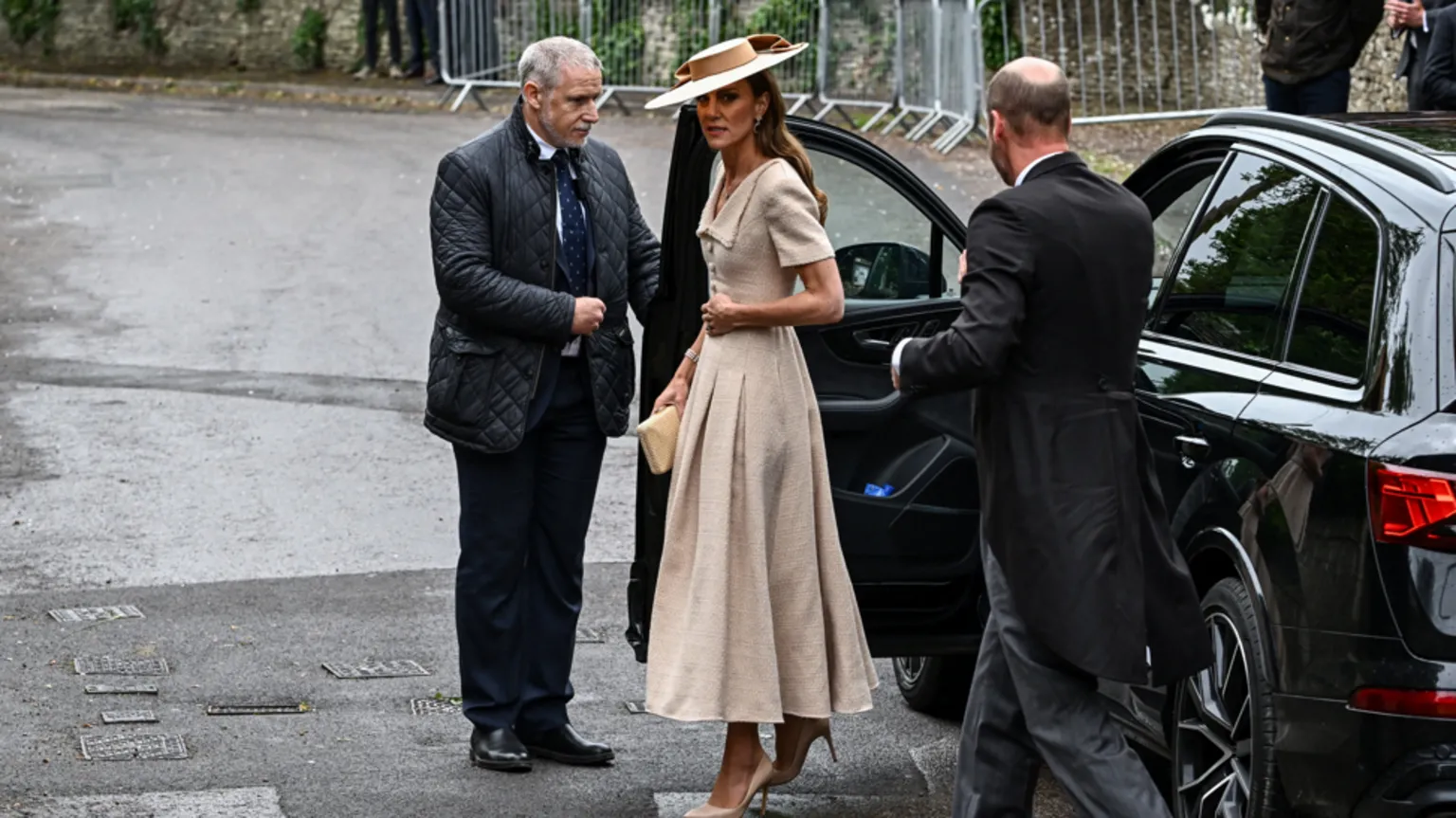  The Princess of Wales has just walked out a car, followed by the Princes of Wales.