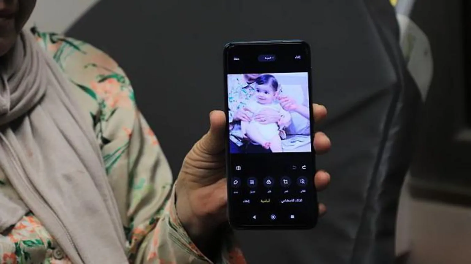 Anadolu via A relative holds up a phone showing a photo of Sam Fahd Abu Haikal, a seven month old baby Palestinian boy who was killed by an Israeli bullet in the occupied West Bank on 5 June 2026.