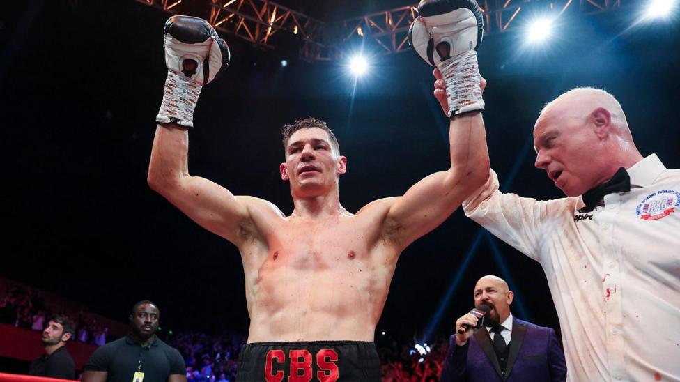 Chris Billam-Smith has his arms held aloft by a referee