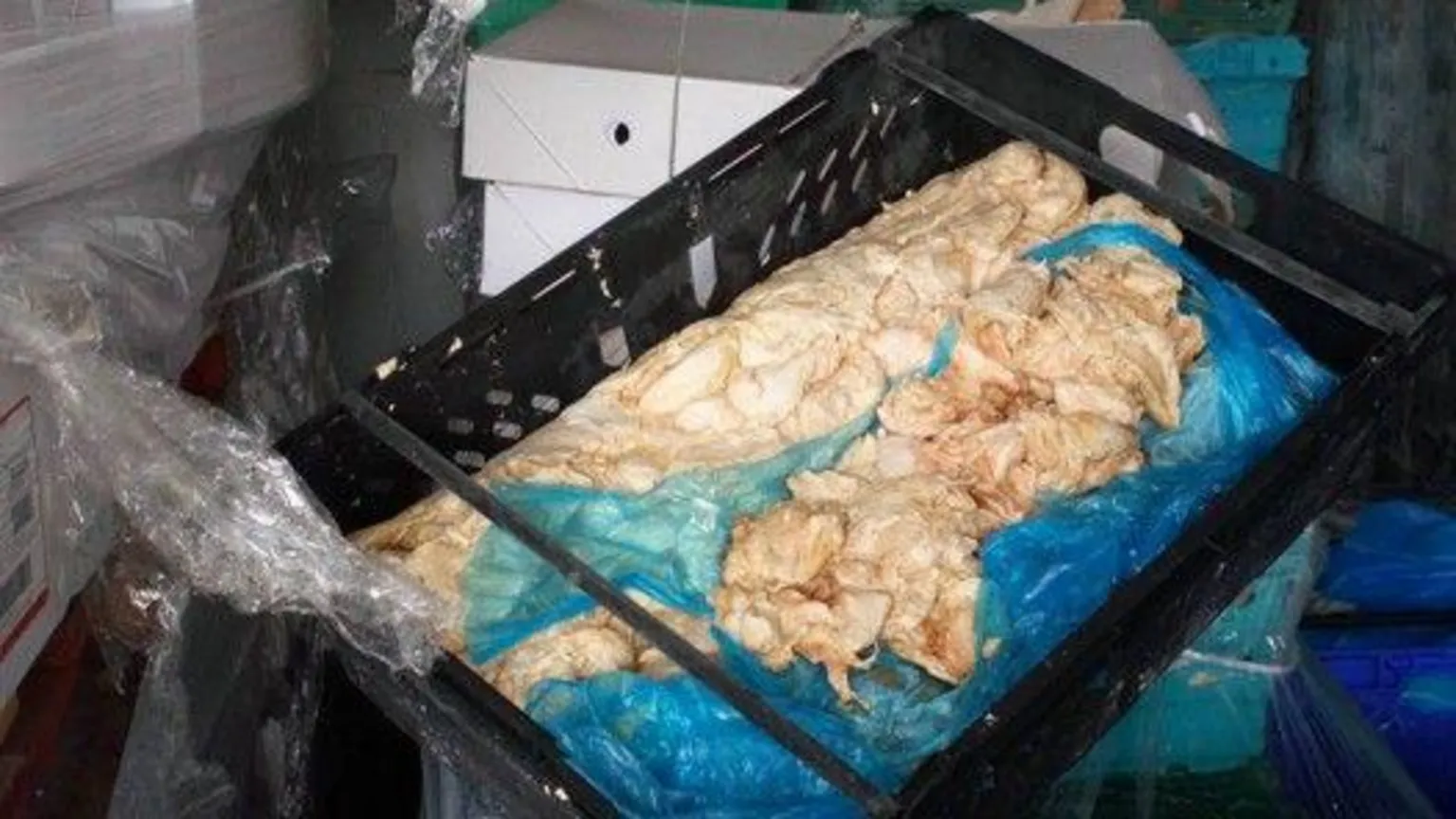 Media Wales Flesh-coloured meat products on blue plastic in black crate