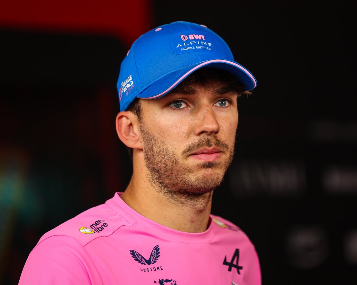 Formula 1 driver Pierre Gasly, wearing a blue hat and pink shirt, looks sadly at the camera after the Monaco Grand Prix.