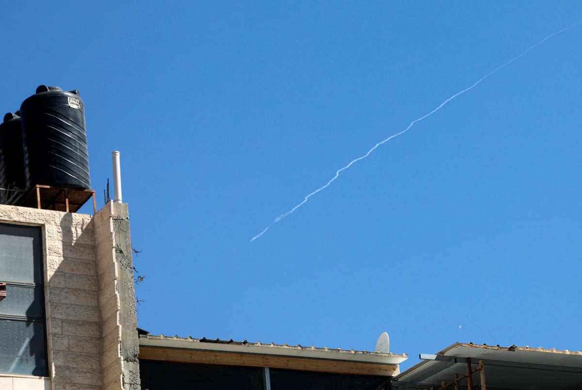 Smoke trails from Iranian missiles launched toward Israel are seen in the sky over the West Bank city of Hebron.