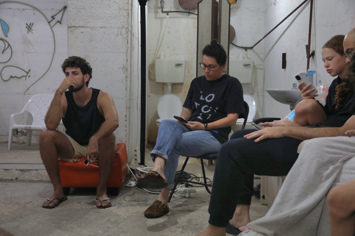 People stay in a bomb shelter to avoid missile attacks in Tel Aviv, Israel.