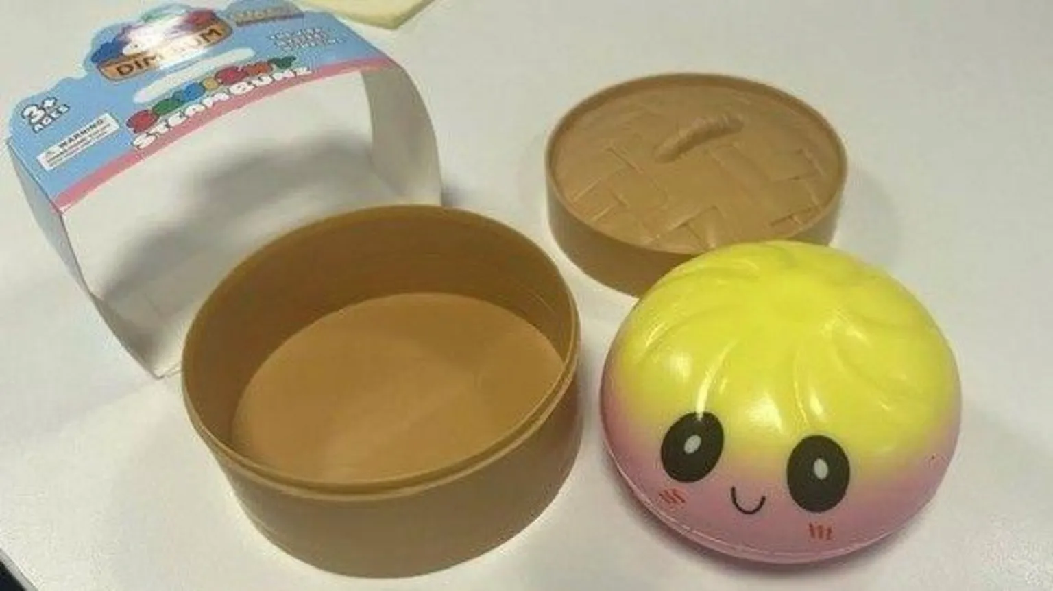 Glasgow City Council A squishy dumpling toy, unboxed and sitting on a table. It is coloured yellow and pink.