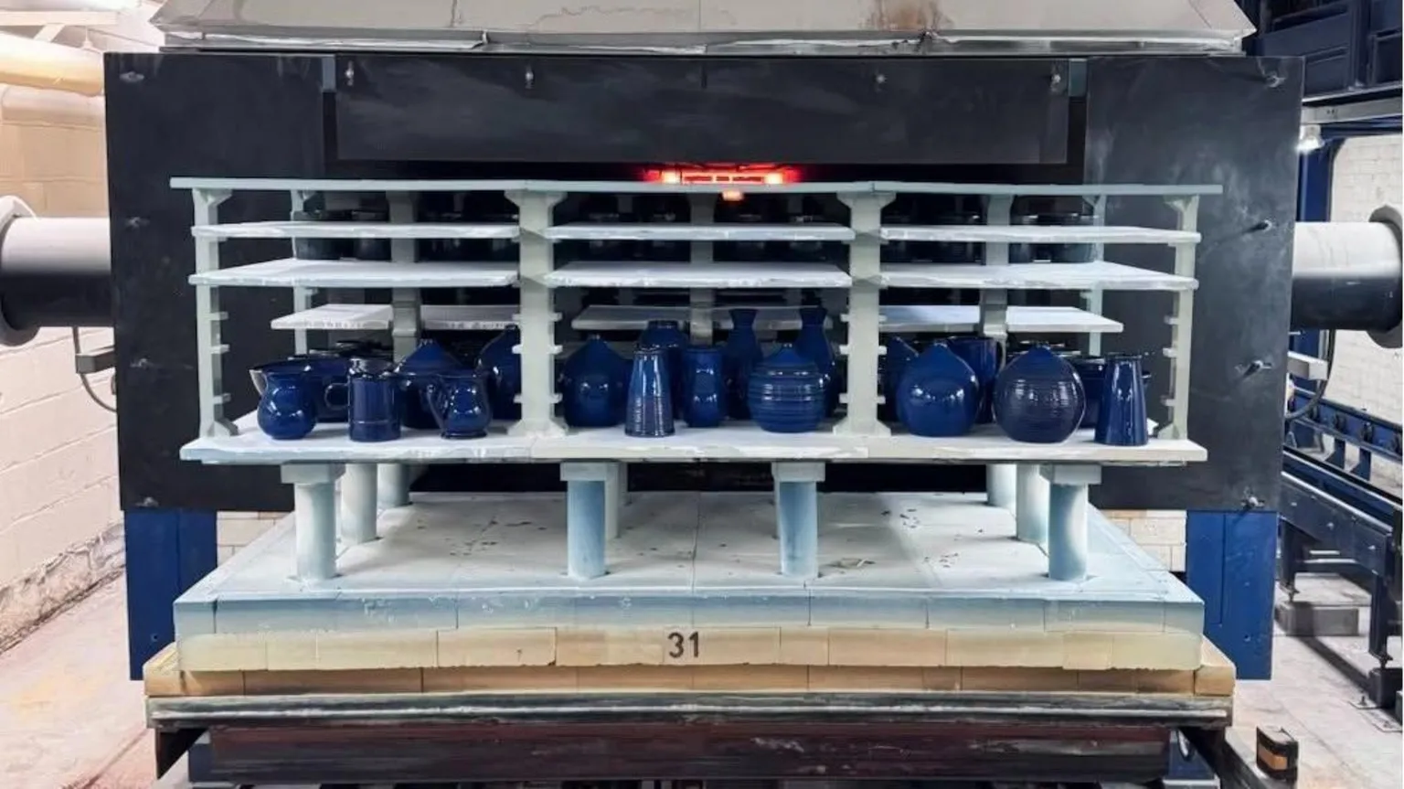 Denby A collection of imperial blue pottery in a large kiln